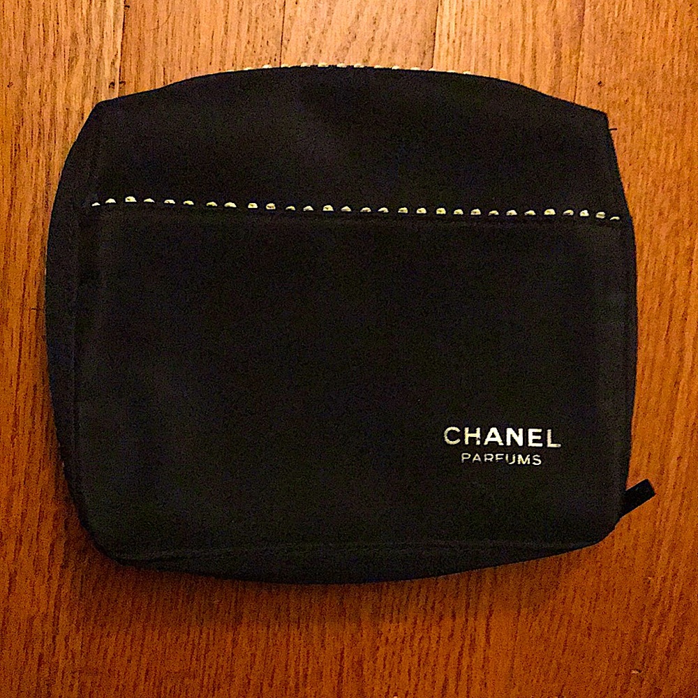 Like new, black Chanel bag with silver ribbon design.